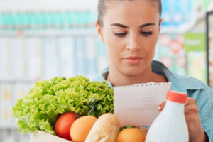 young woman checking grocery list